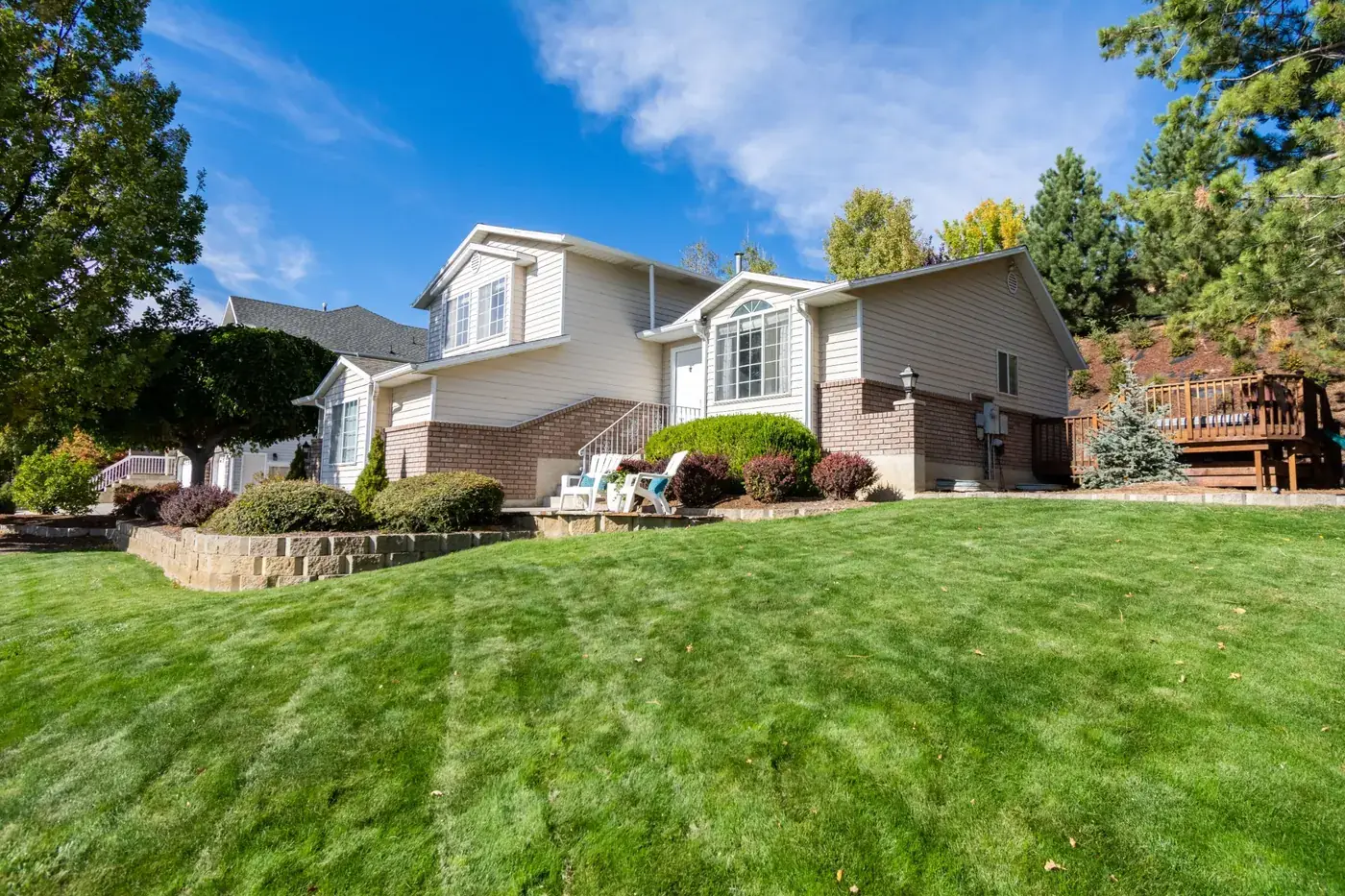 Two-story suburban home with a front lawn on a sunny day