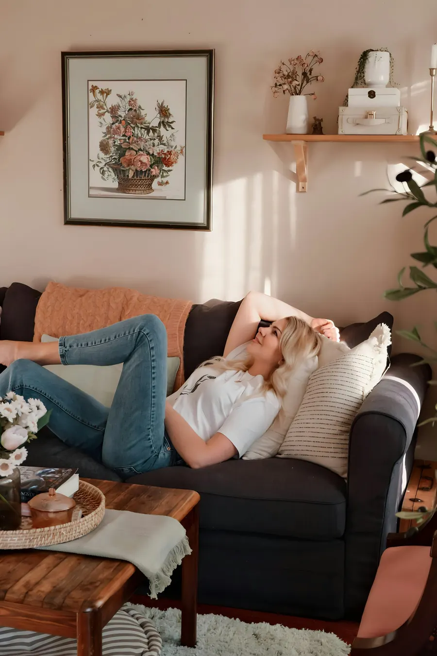 Woman relaxing on a sofa in a cool, sunlit living room